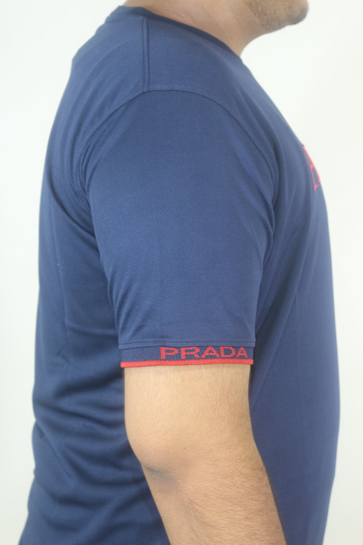 Close-up of a person wearing blue shorts with a visible brand logo on a white background