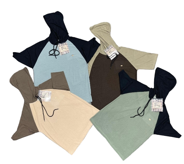 Five hoodies in different colors laid out on a gray surface