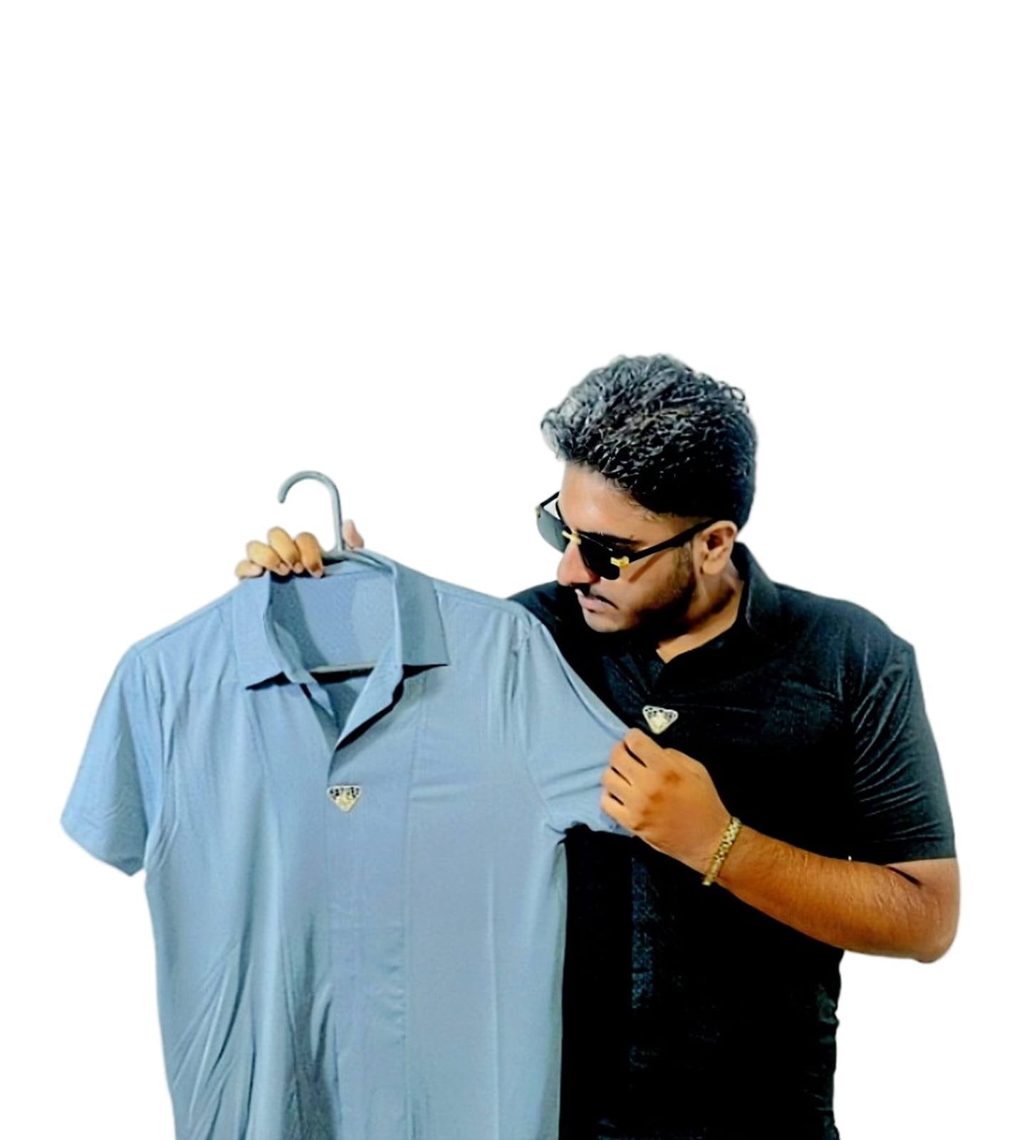 Man holding a light blue shirt on a hanger against a white background