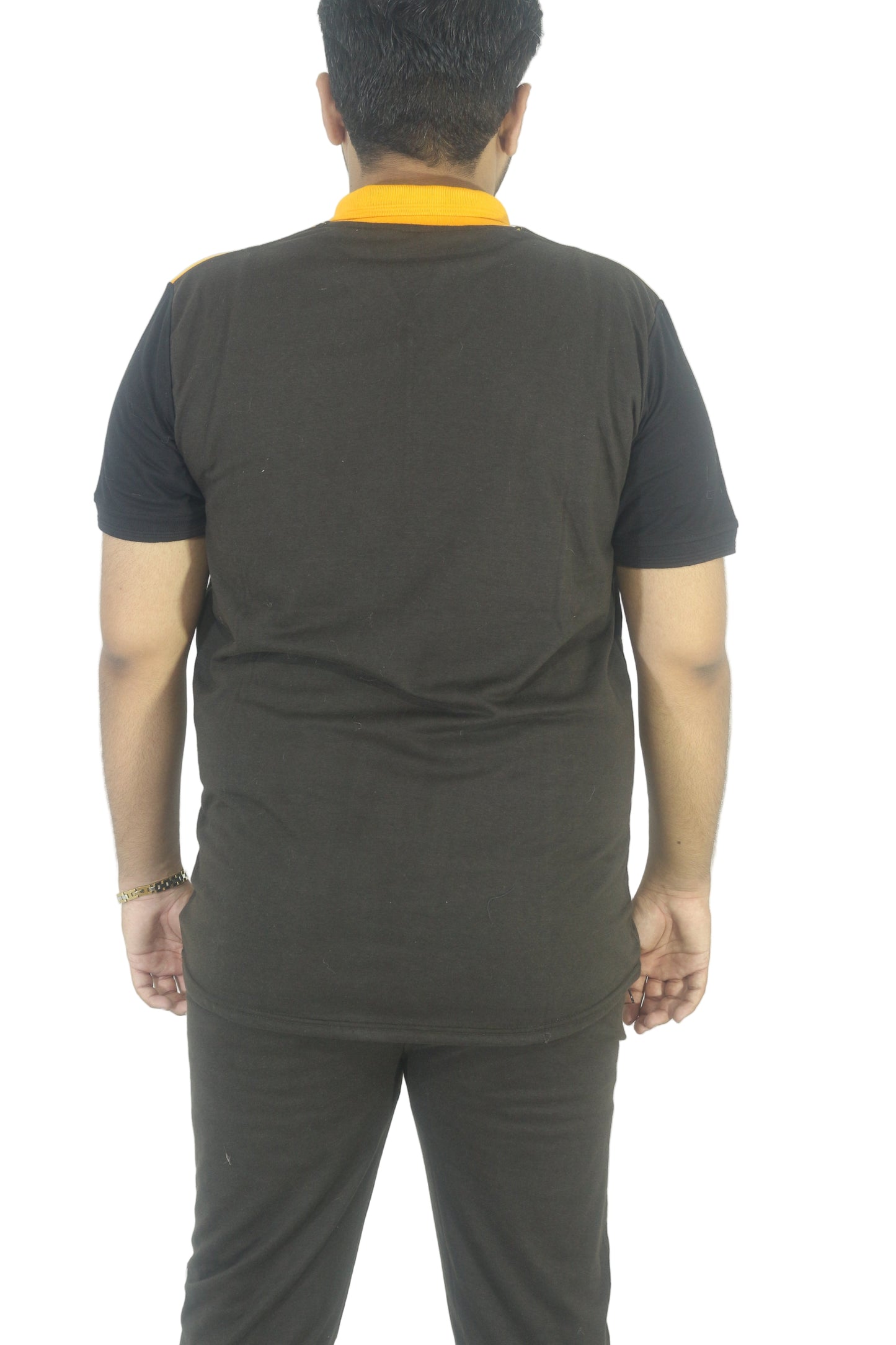 Person wearing a black t-shirt and gray pants on a white background