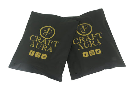 Two black packaging bags with 'Craft Aura' logo and social media icons on a white background